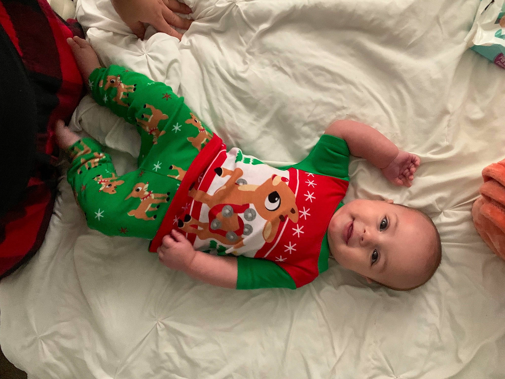 Gracie is registered to the contest to win money with this photo: baby, baby_toddler_clothing, christmas, christmas_decoration, christmas_eve, comfort, fictional_character, hand, holiday, human, joy, linens, nightwear, person, santa_claus, sock