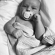 Brandon Jr is registered to the contest to win money with this photo: baby, infant, pacifier, blanket, wrapped, sleeping_area, portrait, monochrome, black_and_white, cute, child, newborn, skin, hand, face, peaceful, soft_texture, lying_down, closeup, resting