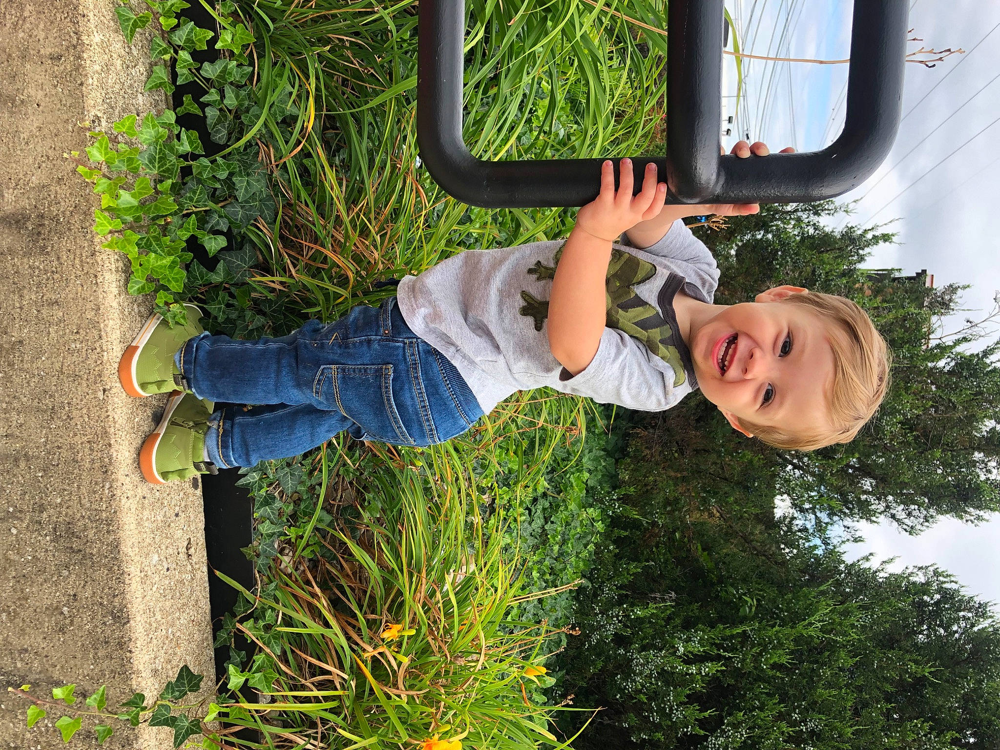 Hayes is registered to the contest to win money with this photo: baby_toddler_clothing, child, denim, electric_blue, fun, garden, grass, happy, joy, leisure, people_in_nature, person, plant, play, shrub, smile, t_shirt, toddler, tree