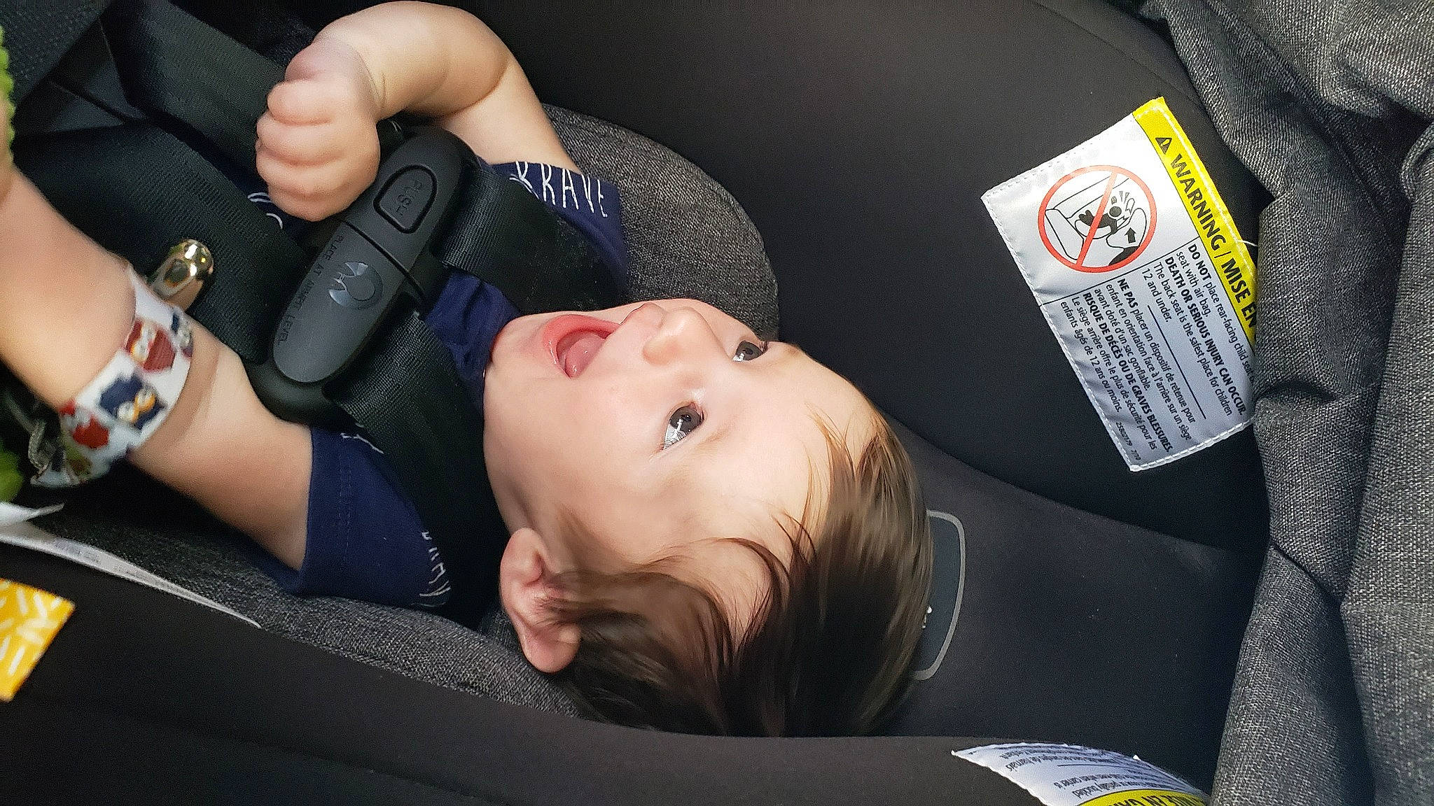 Finnegan is registered to the contest to win money with this photo: arm, car_seat, child, neck, person