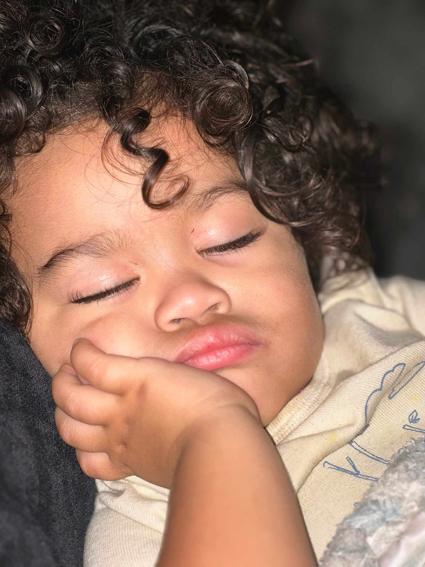 Azhainei joined the competition — help win amazing prizes! child, sleeping, curly_hair, closeup, hand, face, peaceful, blanket, soft_lighting, indoors, cozy, resting, eyelashes, skin, portrait, relaxation, toddler, clothing, nap, cute