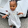 Malani joined the competition — help win amazing prizes! baby, bow, car, child, cute, dress, expression, hair, hand, necklace, outdoor, pavement, person, playful, sneakers, standing, toddler, tongue_out, white, young