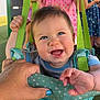baby, child, swing, smile, happy, hand, blue_nail_polish, clothing, outdoor, playground, person, fabric, strap, green, pink, dress, fun, summer, people, face
