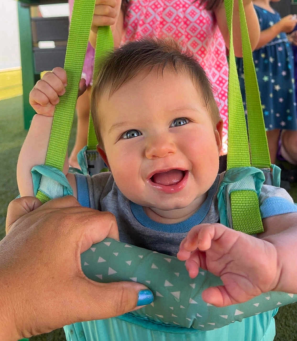 Hudson joined the competition — help win amazing prizes! baby, child, swing, smile, happy, hand, blue_nail_polish, clothing, outdoor, playground, person, fabric, strap, green, pink, dress, fun, summer, people, face