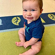 Hudson is registered to the contest to win money with this photo: baby, child, infant, blue_eyes, smile, sitting, onesie, carpet, indoor, cute, cheeks, hands, feet, floor, hair, person, portrait, happy, toddler, bright