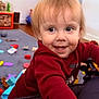 Liam joined the competition — help win amazing prizes! carpet, child, closeup, cute, eyes, face, floor, hair, hand, happy, indoor, living_room, person, playroom, portrait, red_sweater, smile, toddler, toy_car, toys
