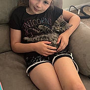 Precious joined the competition — help win amazing prizes! animal, black_tshirt, carpet, cat, child, couch, cute, girl, holding, home, indoor, kitten, light, pet, relaxing, seated, shorts, smile, window, young