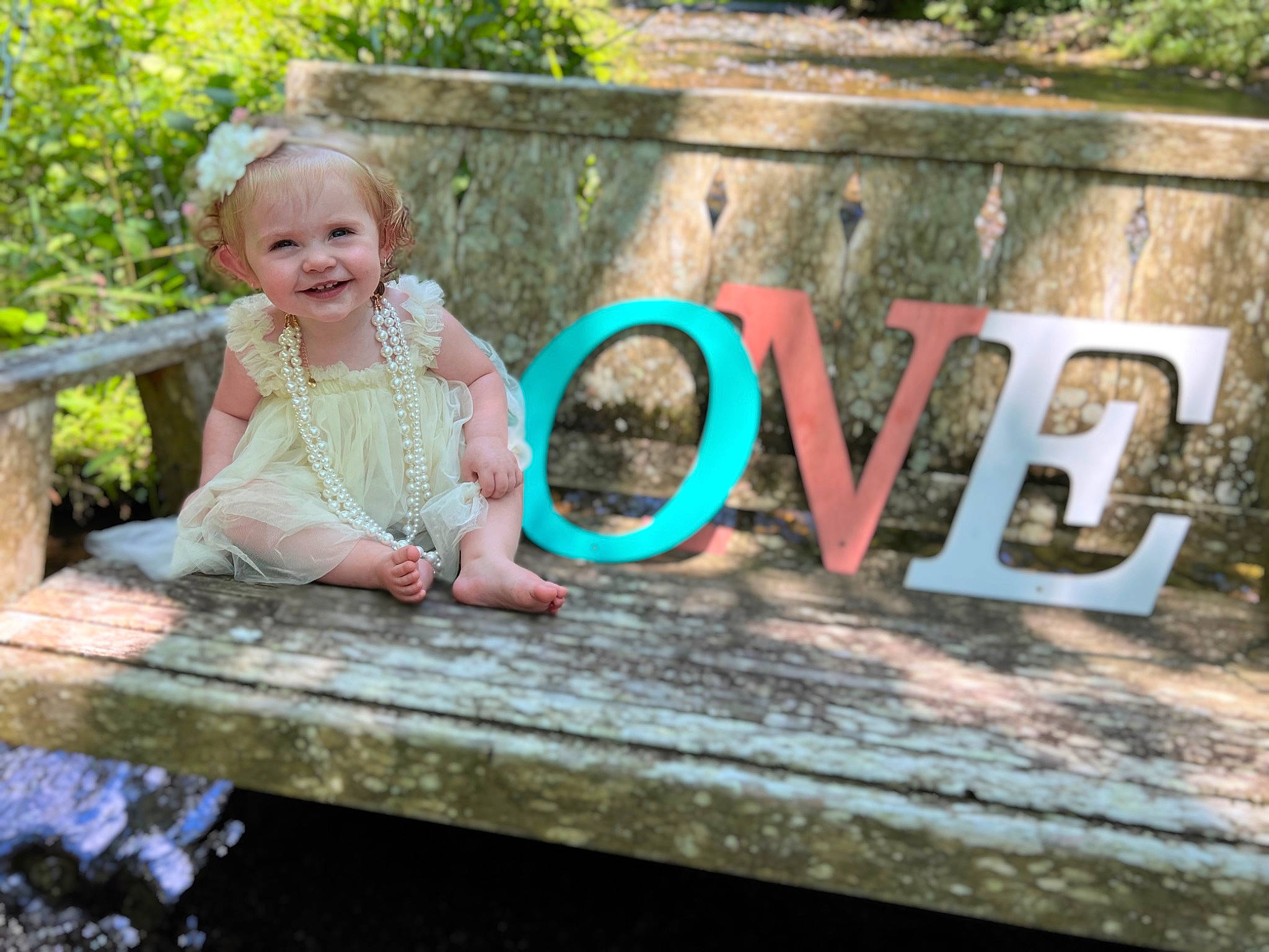 Ila joined the competition — help win amazing prizes! baby_toddler_clothing, child, dress, font, fun, garden, grass, happy, joy, landscape, leisure, magenta, people_in_nature, person, plant, recreation, sitting, smile, spring, summer