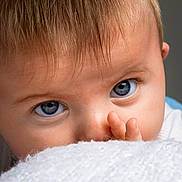Clara joined the competition — help win amazing prizes! baby, blanket, blue_eyes, child, close_up, curious, cute, expression, eyelashes, face, fingers, hair, indoors, infant, nose, person, portrait, skin, soft_texture, young