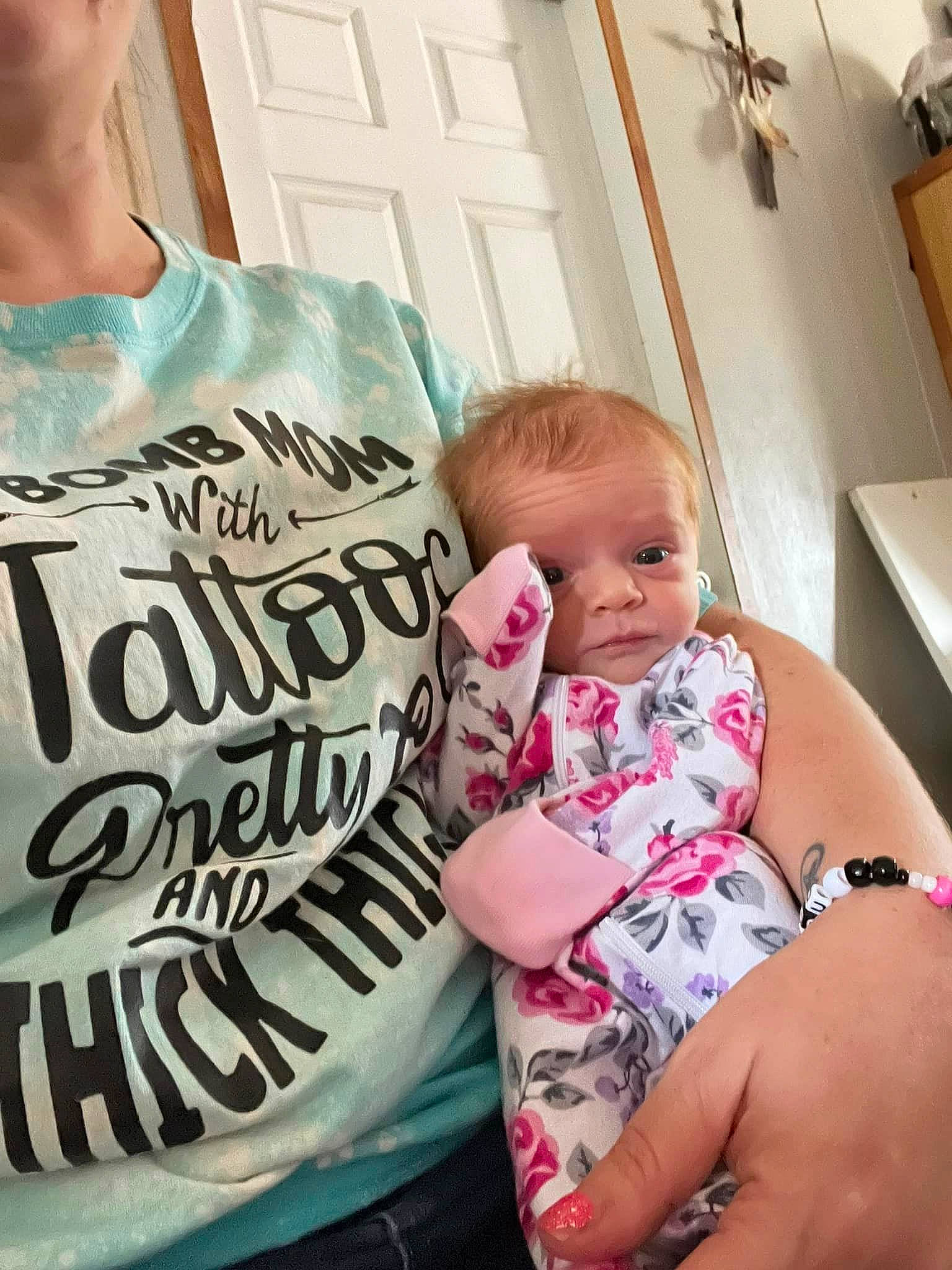 Bristol is registered to the contest to win money with this photo: arm, baby, comfort, eye, eyelash, facial_expression, hairstyle, happy, head, human_body, joint, mouth, muscle, neck, person, pink, product, shoulder, skin, sleeve