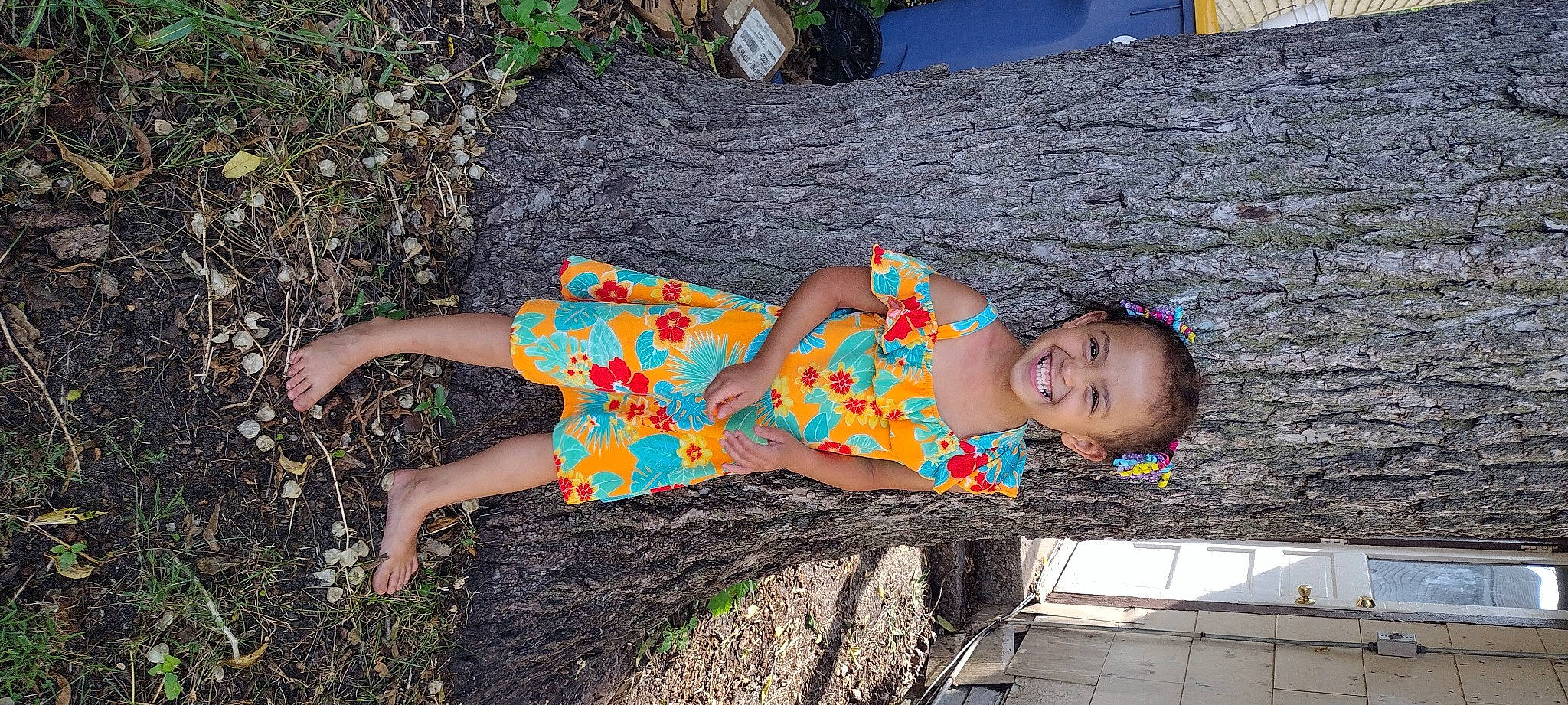Aaylah is registered to the contest to win money with this photo: adaptation, dress, fun, grass, happy, human_leg, joy, leisure, pattern, people_in_nature, person, pink, plant, summer, textile, thigh, tints_and_shades, toddler, tree, trunk