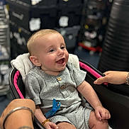 Hudson joined the competition — help win amazing prizes! baby, smiling, stroller, grey_outfit, wooden_buttons, hands, bracelet, infant, seat, happy, portrait, indoor, child, cute, person, young, clothing, blanket, closeup, comfort