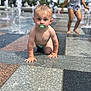 Hudson is registered to the contest to win money with this photo: baby, barefoot, child, crawling, fountain, fun, outdoor, pacifier, park, pavement, people, play, playground, splash_park, summer, sunny, tiles, toddler, water, wet
