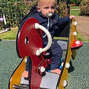 Hudson joined the competition — help win amazing prizes! barefoot, child, clouds, daylight, fence, greenery, leisure, nature, outdoor, pacifier, park, play_area, playground, rocker, sign, sky, sunlight, toddler, toy, tracksuit