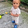 Milow participe au concours pour gagner de l'argent avec cette photo : bunny, child, concrete, curious, cute, expression, footwear, garden, greenery, outdoor, person, play, sandals, shorts, standing, summer, toddler, toy, tshirt, young