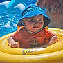 Maëlyo a rejoint le concours — aidez-le/la à gagner de superbes lots ! toddler, child, pool, inflatable_ring, blue_hat, orange_shirt, water, summer, sunlight, adult, shirtless, floating, outdoor, bright, yellow, splash, fun, vacation, cute, sunny