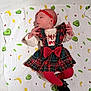 baby, infant, child, blanket, avocado_pattern, banana_pattern, red_headband, tartan_dress, red_bow, red_tights, black_shoes, lying_down, curious_expression, indoor, soft_texture, cute, small_hands, clothing, portrait, colorful