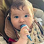 baby, bib, blue_eyes, child, clothing, cute, expression, face, feeding, food, hair, hand, high_chair, indoor, infant, looking_at_camera, messy, person, seat, spoon