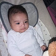 Ibrahim joined the competition — help win amazing prizes! baby, baby_seat, child, comfort, cozy, cushion, cute, face, hand, indoor, infant, looking, portrait, resting, sleepwear, small_person, soft_toy, toy, white_clothing, young_child