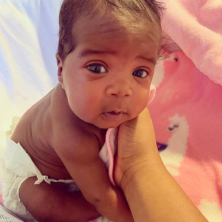 Camille is registered to the contest to win money with this photo: arm, baby, beauty, blond, cheek, child, chin, close_up, eye, eyebrow, face, forehead, hair, hand, head, human, lip, nose, person, skin