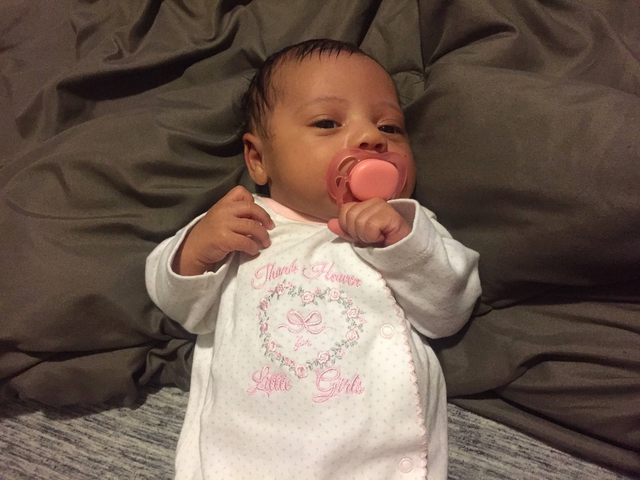 Layla is registered to the contest to win money with this photo: arm, baby, baby_products, baby_toddler_clothing, cheek, child, eye, face, finger, hand, head, mouth, nose, person, pink, product, sleeve, textile, thumb, toddler