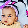 Aurelia is registered to the contest to win money with this photo: baby, blanket, bow, closeup, clothing, cozy, cute, expression, eyes, face, headband, indoor, infant, person, pink, portrait, skin, soft, yellow, young_child