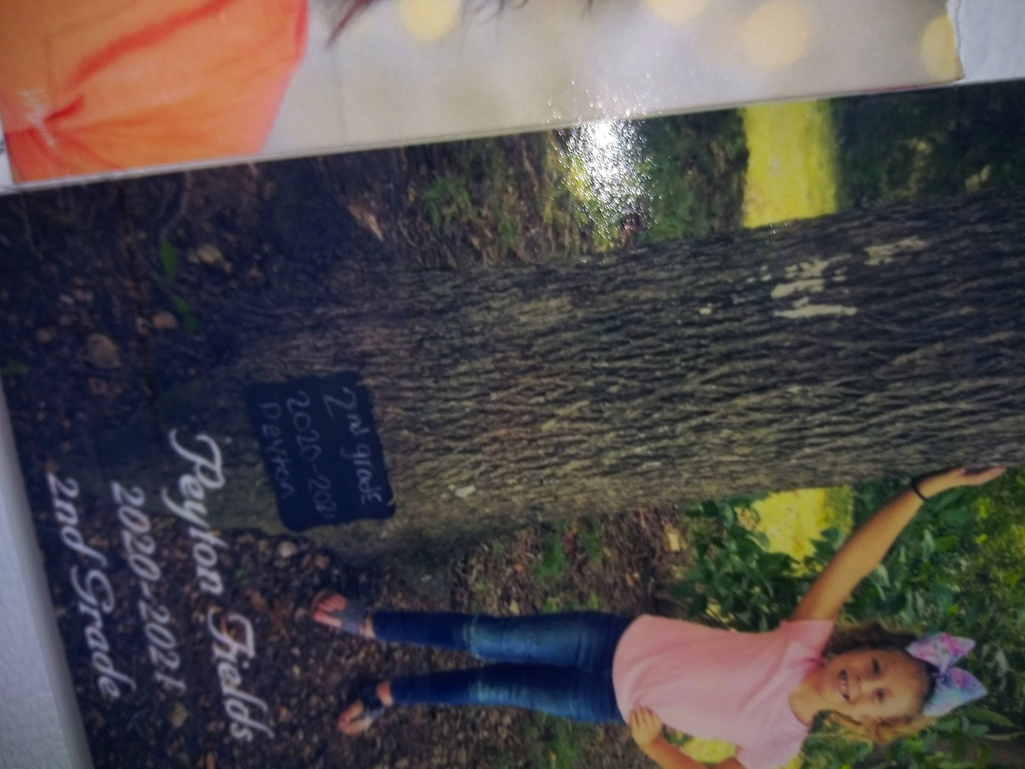 Peyton is registered to the contest to win money with this photo: bumper, chalk, fun, glass, handwriting, joy, leisure, paint, person, plant, room, smile, t_shirt, thigh, tree, wood