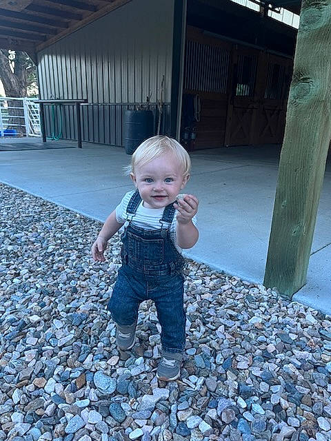 Lance is registered to the contest to win money with this photo: asphalt, baby, blue, child, cobblestone, electric_blue, eye, floor, flooring, fun, grass, joy, leisure, people_in_nature, person, public_space, road_surface, sidewalk, sitting, standing