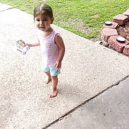 Harmony joined the competition — help win amazing prizes! barefoot, blueberry, casual_clothing, child, concrete, curious_expression, daylight, garden_border, grass, outdoor, packet, playful, red_bricks, shorts, sidewalk, snack, summer, tank_top, toddler, young_child