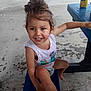 Harmony joined the competition — help win amazing prizes! barefoot, bench, blue, casual, child, concrete_floor, covered_area, daylight, drink_can, fanta_can, girl, hair_bun, happy, outdoor, playful, sitting, smile, table, white_shirt, young_child