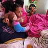 child, bed, blanket, stuffed_doll, chicken_nugget, food, pillow, pink, flower, indoor, relaxing, toy, person, hair, curly_hair, casual, comfort, snack, young, cozy