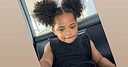 Ahniaya Jones joined the competition — help win amazing prizes! child, car_interior, black_clothing, curly_hair, pigtails, shorts, heart_pattern, seat, window, daylight, casual, portrait, cute, thinking, young_child, sitting, indoors, relaxed, skin, person