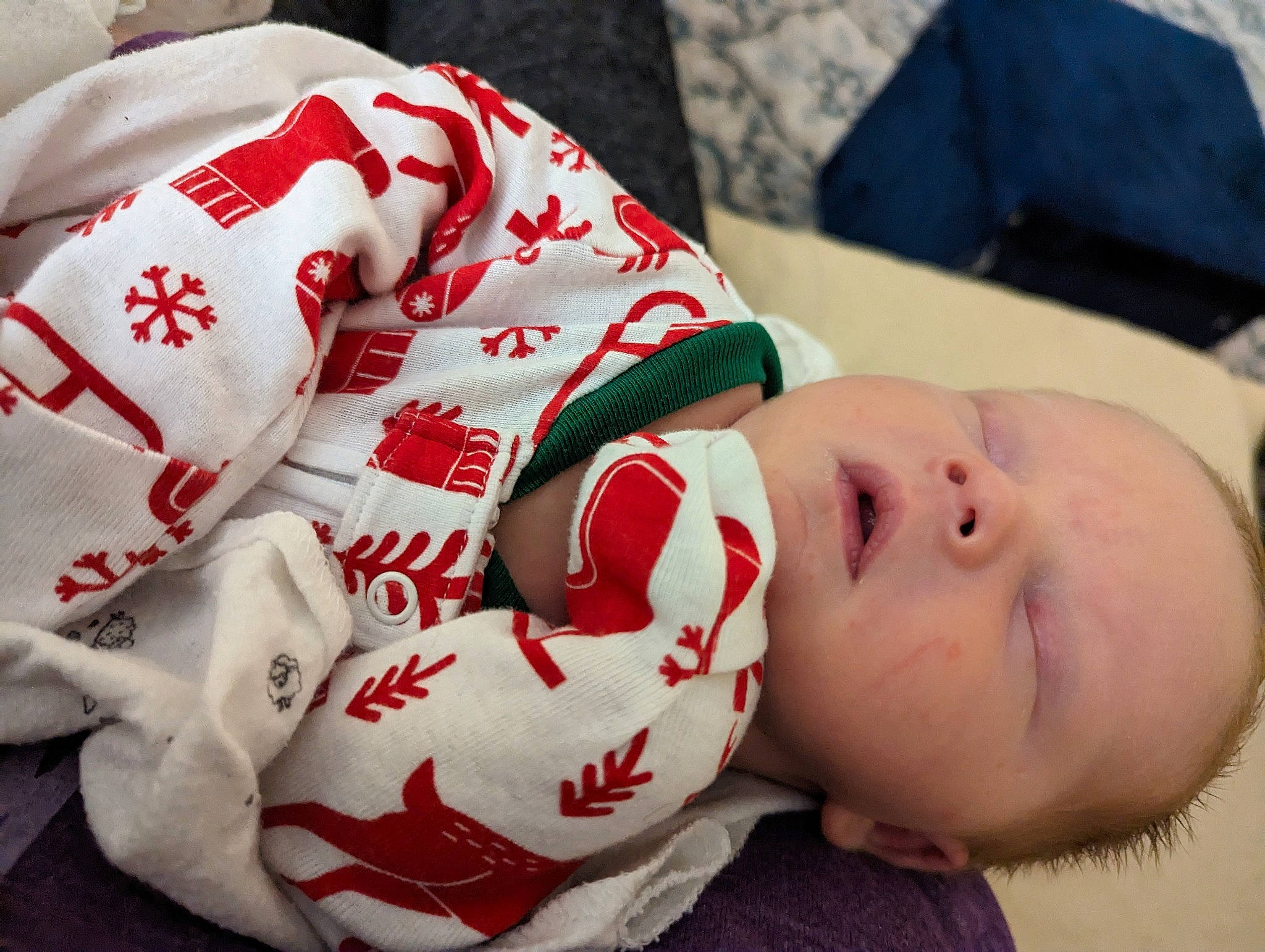 Caiden is registered to the contest to win money with this photo: baby, baby_toddler_clothing, carmine, child, christmas, comfort, elbow, event, face, finger, flag_of_the_united_states, flesh, hand, happy, headgear, holiday, linens, pattern, person, textile