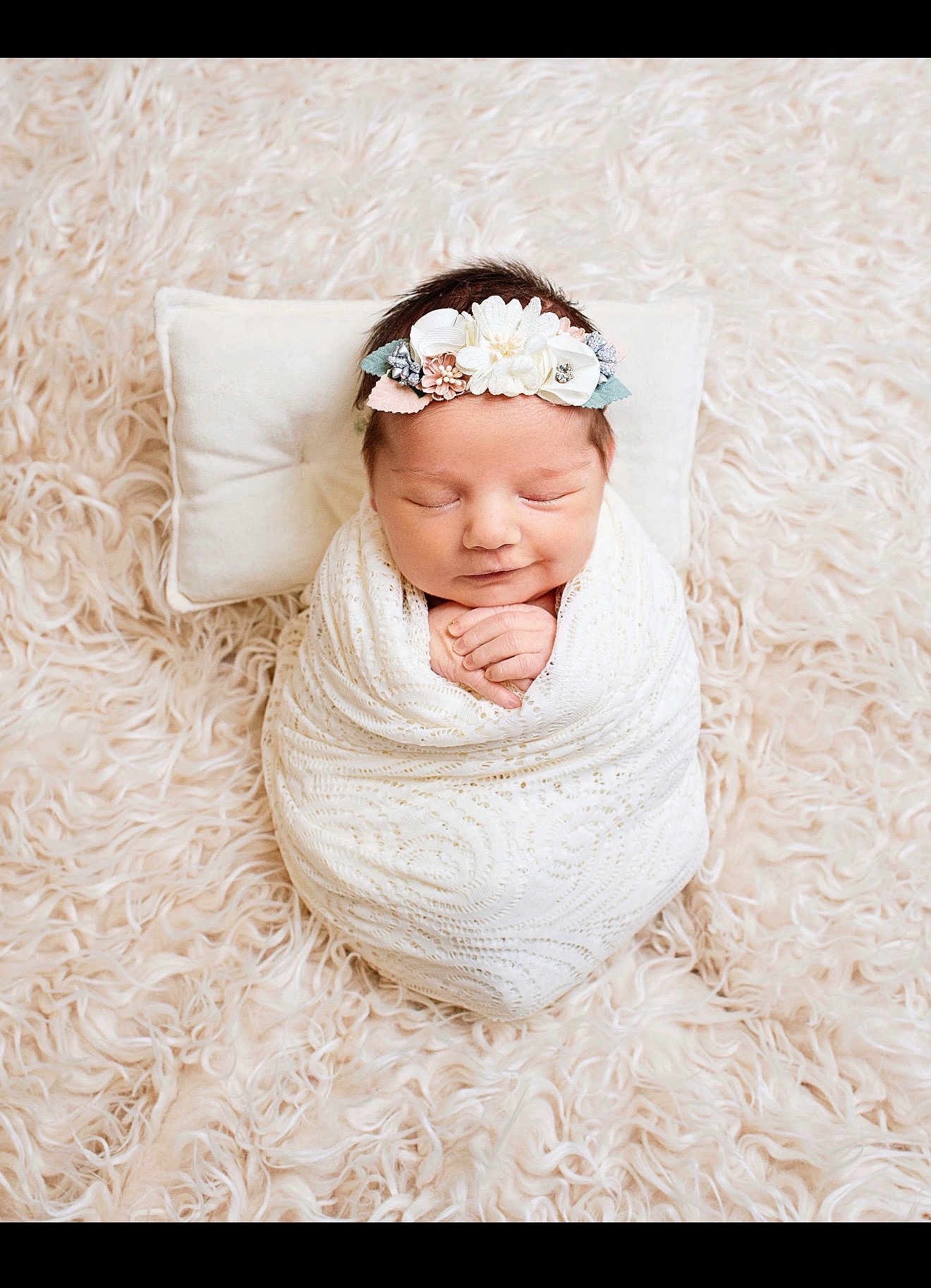 Juliana is registered to the contest to win money with this photo: newborn, baby, swaddled, blanket, headband, flower, pillow, carpet, fluffy, smile, sleeping, infant, cute, portrait, soft, peaceful, hands, wrapped, cozy, indoors