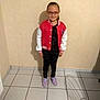 Kimberley participe au concours pour gagner de l'argent avec cette photo : black_pants, casual_clothing, child, floor_tiles, full_body, girl, glasses, home, indoor, long_hair, person, portrait, purple_shoes, red_jacket, shadow, smiling, standing, tiled_floor, wall, young