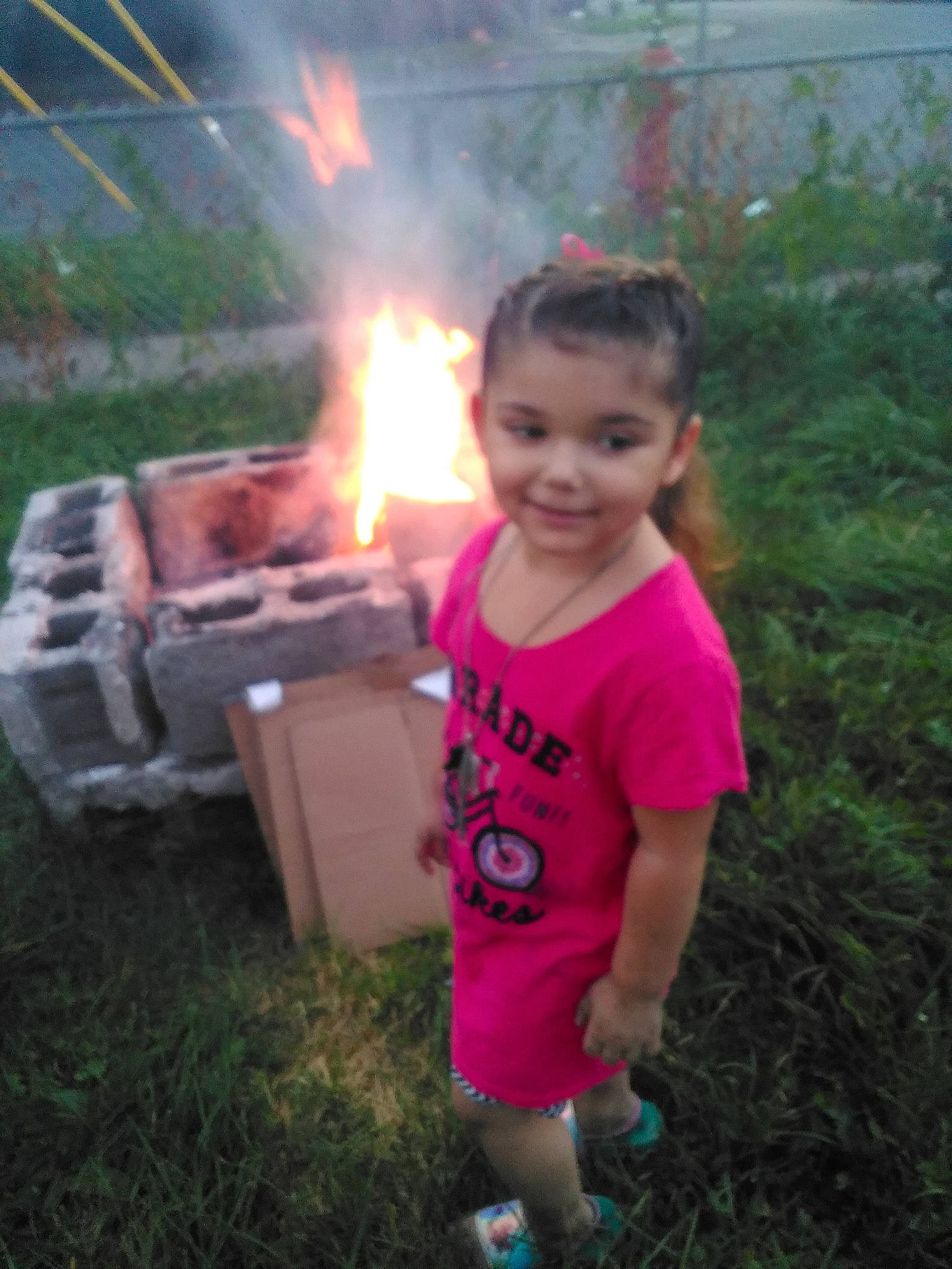 Olivia joined the competition — help win amazing prizes! bonfire, campfire, event, fire, flame, fun, gas, grass, happy, heat, joy, landscape, leisure, person, plant, recreation, shorts, smile, smoke, t_shirt