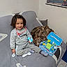 blanket, casual, child, couch, doctor_kit, floor_tiles, happy, home, indoor, person, pillow, play, smiling, socks, stethoscope, sweatpants, sweatshirt, toddler, toy, world_map