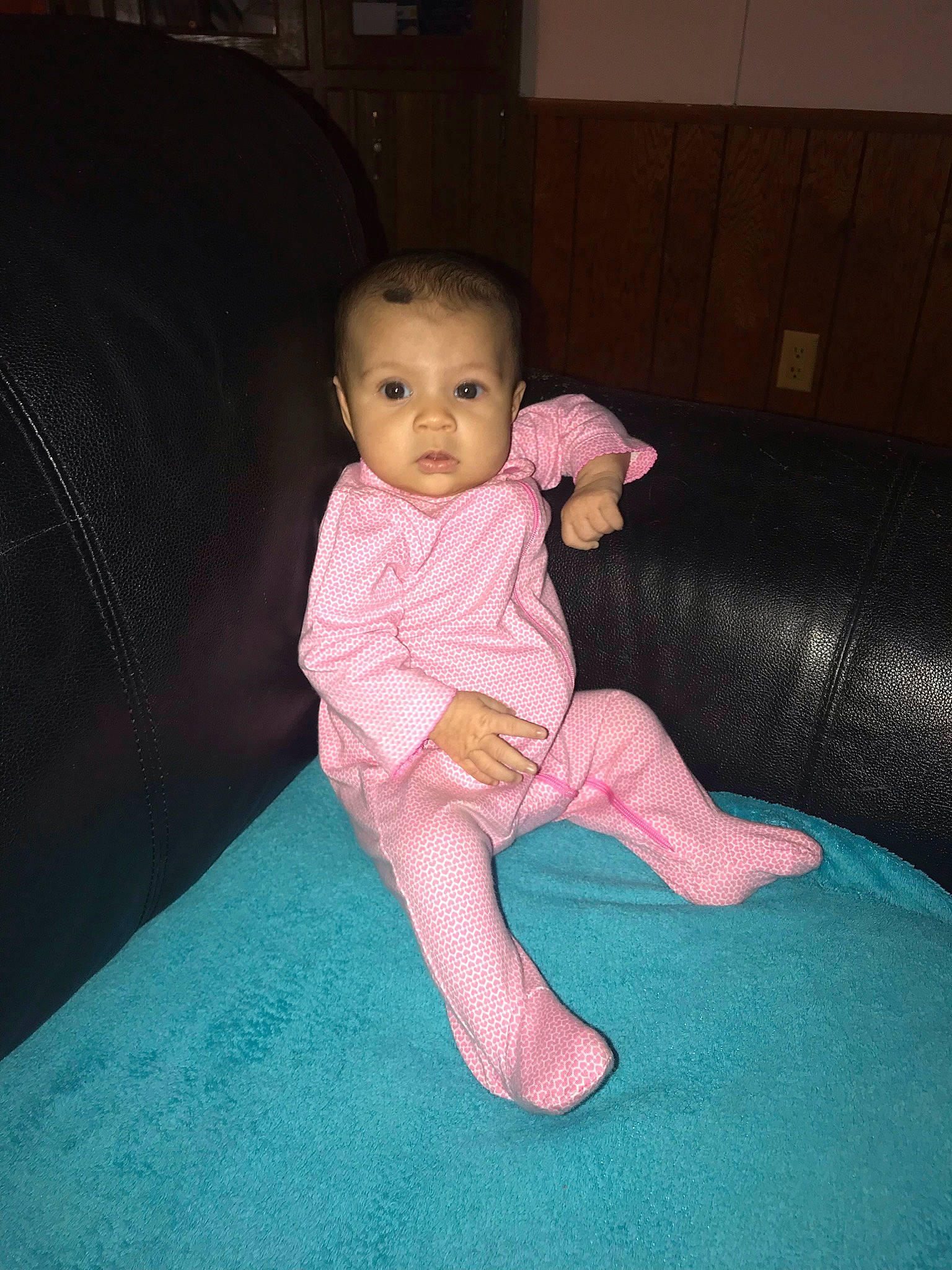 Avalynn is registered to the contest to win money with this photo: arm, baby, baby_toddler_clothing, barefoot, cheek, comfort, couch, finger, floor, flooring, foot, fun, human_body, human_leg, lap, leg, person, sleeve, textile, thumb