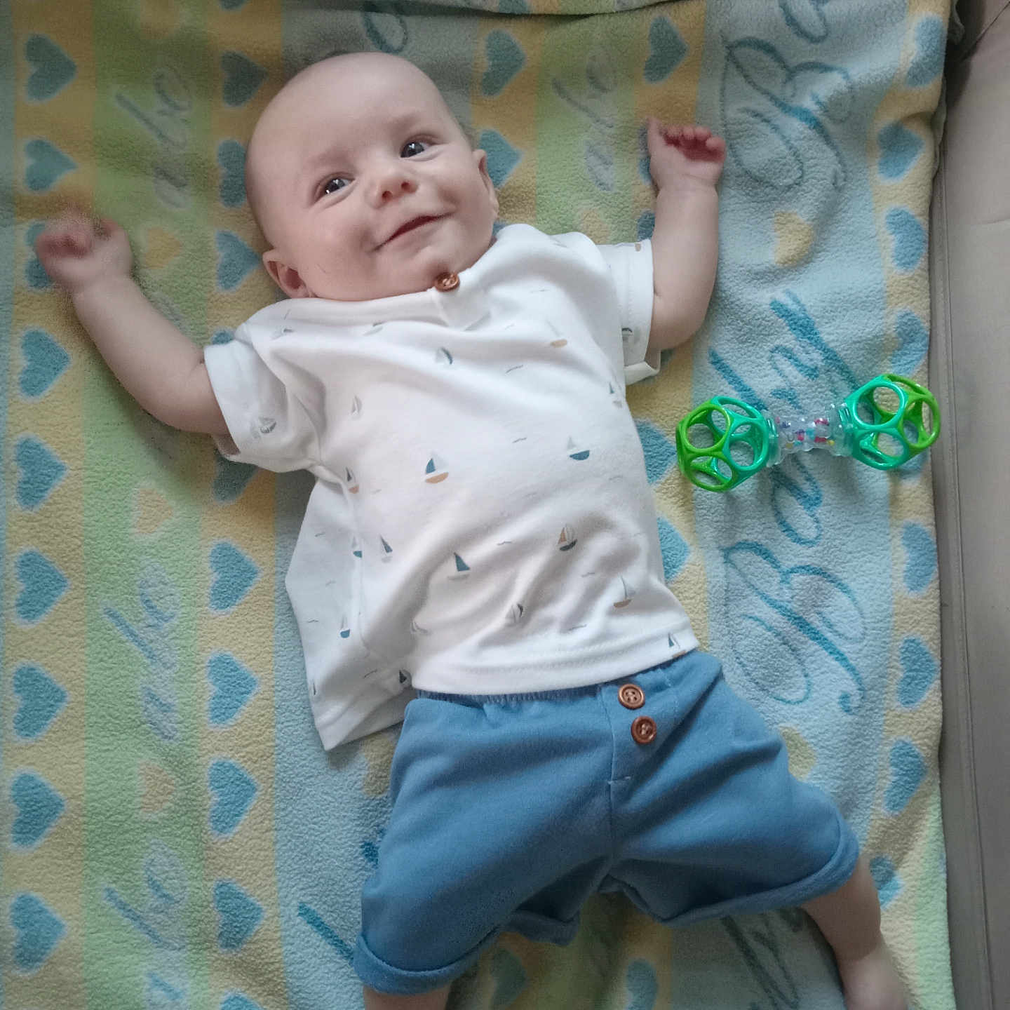 Elijah is registered to the contest to win money with this photo: applique, baby, bed, blanket, clothing, cradle, crib, face, furniture, handcuffs, head, infantbed, jeans, newborn, pants, pattern, person, photography, portrait, shorts