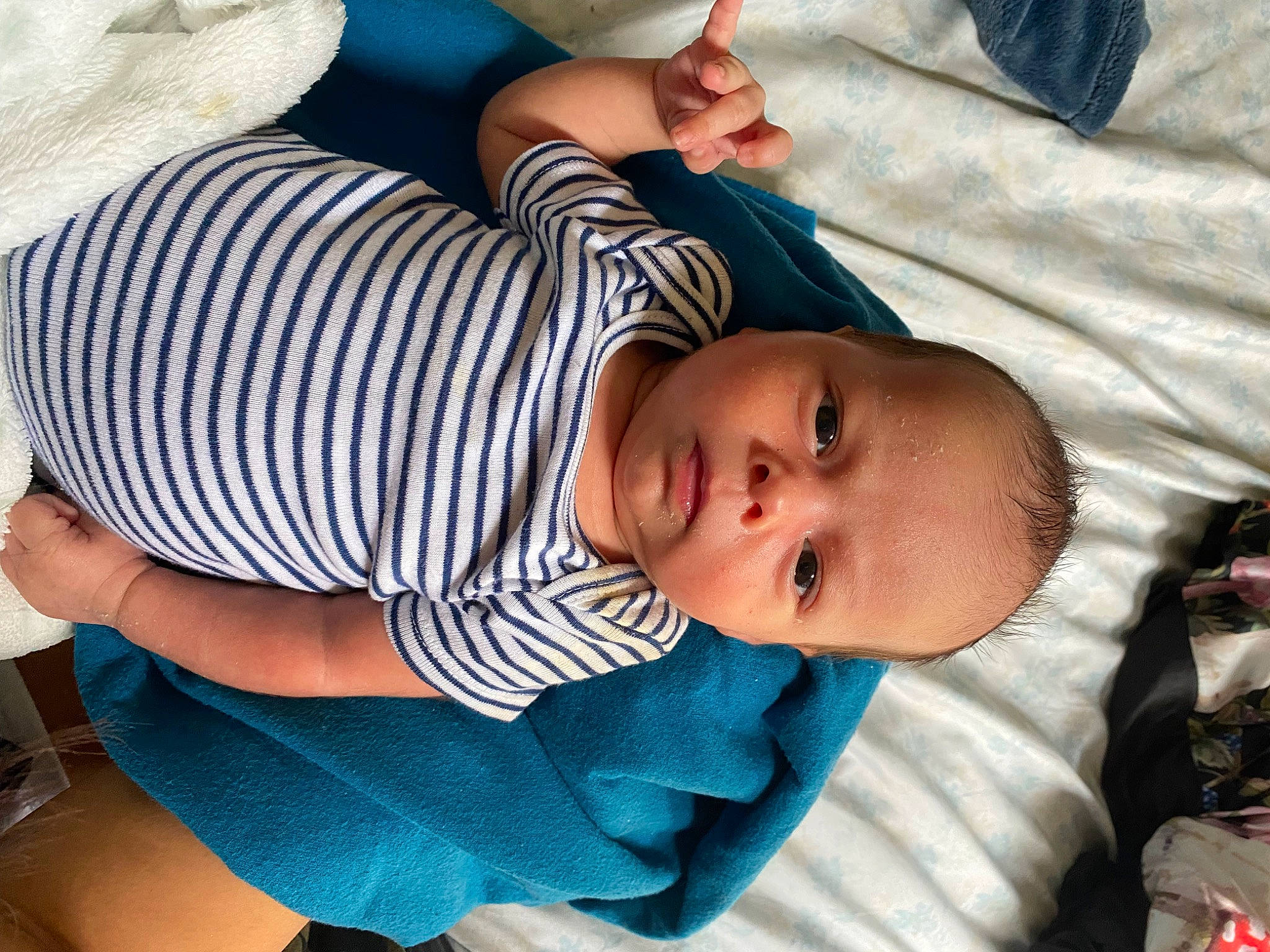 Elias is registered to the contest to win money with this photo: baby, baby_products, baby_toddler_clothing, blue, child, comfort, elbow, facial_expression, finger, gesture, hat, nail, pattern, person, product, sitting, skin, sleeve, thumb, toddler