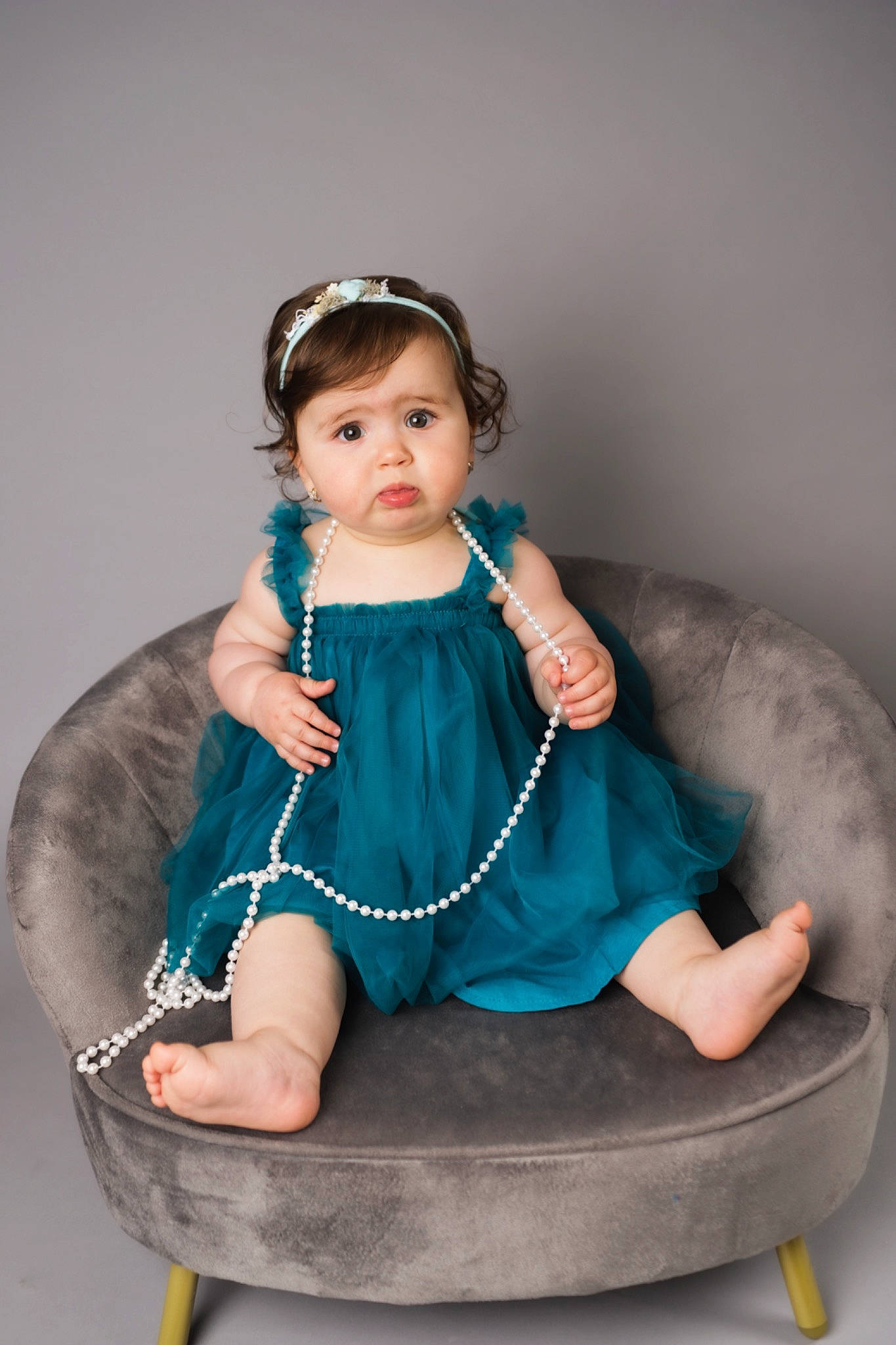 Anais is registered to the contest to win money with this photo: arm, baby, baby_toddler_clothing, chair, cheek, child, circle, comfort, dress, electric_blue, fashion_accessory, fashion_design, flash_photography, hair, jewellery, necklace, person, product, sitting, toddler