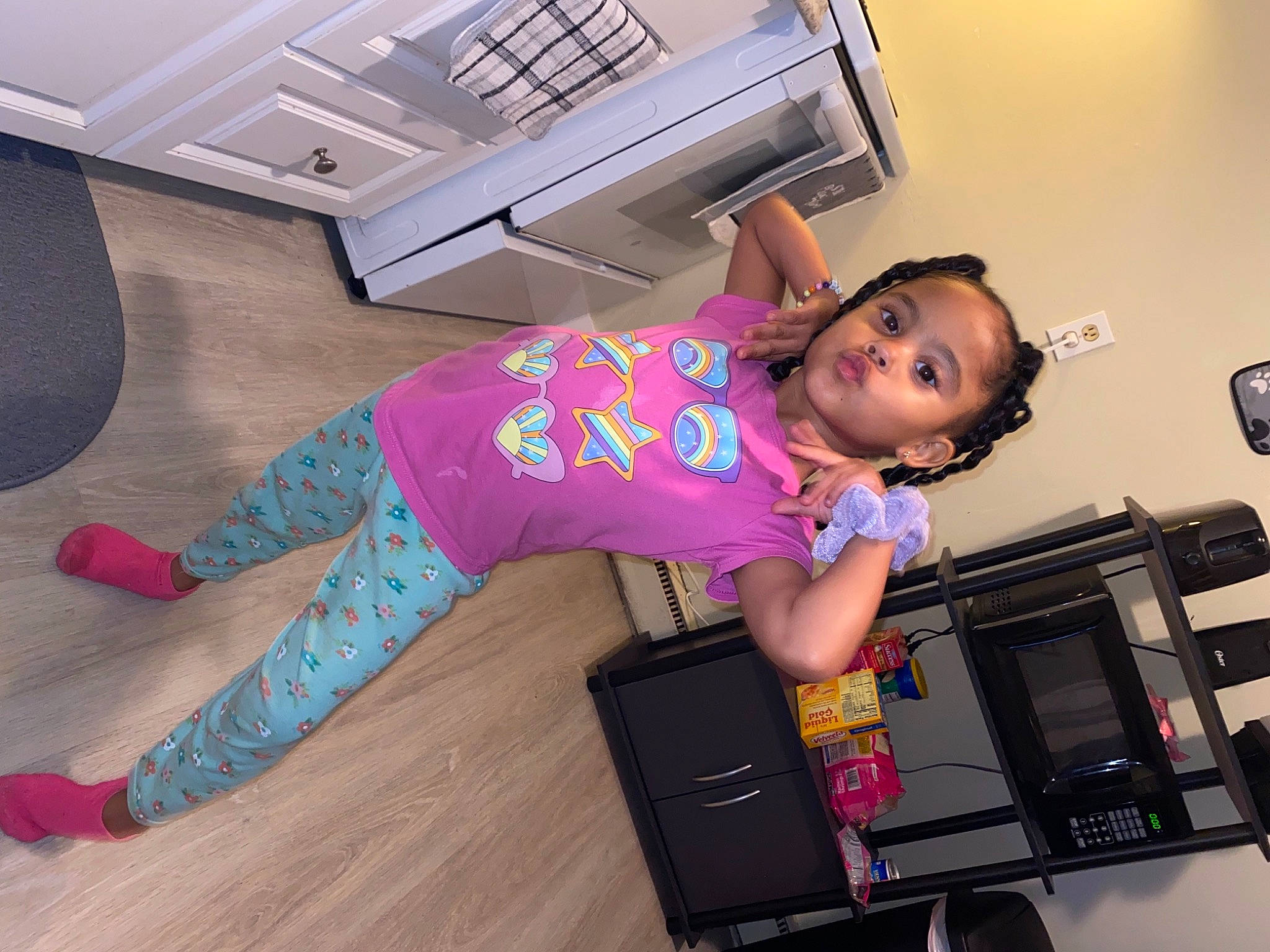 Analyse is registered to the contest to win money with this photo: active_pants, child, floor, flooring, hardwood, house, human_leg, joint, knee, leg, person, pink, shoulder, sleeve, sneakers, sportswear, standing, t_shirt, thigh, toddler