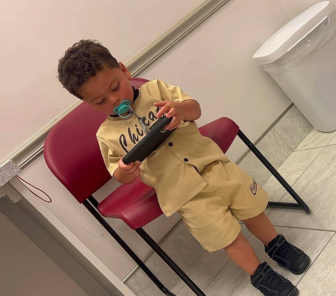 Alexis joined the competition — help win amazing prizes! chair, child, comfort, elbow, fun, happy, human_leg, joint, knee, leisure, metal, person, room, shorts, shoulder, sitting, sleeve, sportswear, t_shirt, thigh