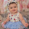 baby, child, infant, sitting, smiling, portrait, headband, bow, tutu, dress, blue, patterned_clothing, indoors, bedroom, soft_focus, carpet, couch, happy, cute, photography