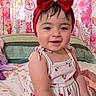 Danelly Anais joined the competition — help win amazing prizes! baby, child, infant, portrait, smiling, happy, red_bow, headband, dress, cherry_pattern, floral, bedroom, bed, bedding, curtains, indoor, sitting, fashion, closeup, photography