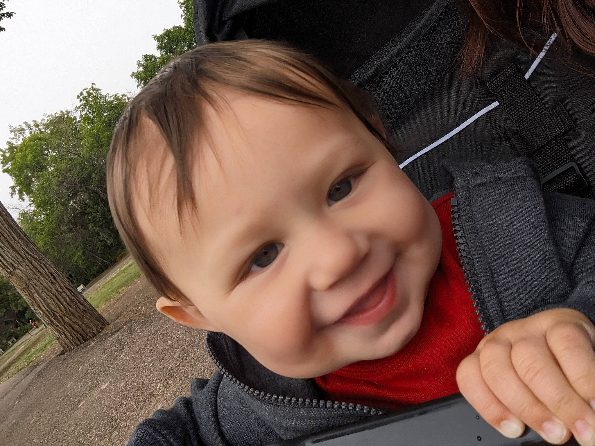 Alistair is registered to the contest to win money with this photo: baby, baby_toddler_clothing, cheek, child, eyelash, fun, gesture, grass, happy, joy, lip, mouth, nose, person, plant, sitting, skin, smile, thumb, toddler