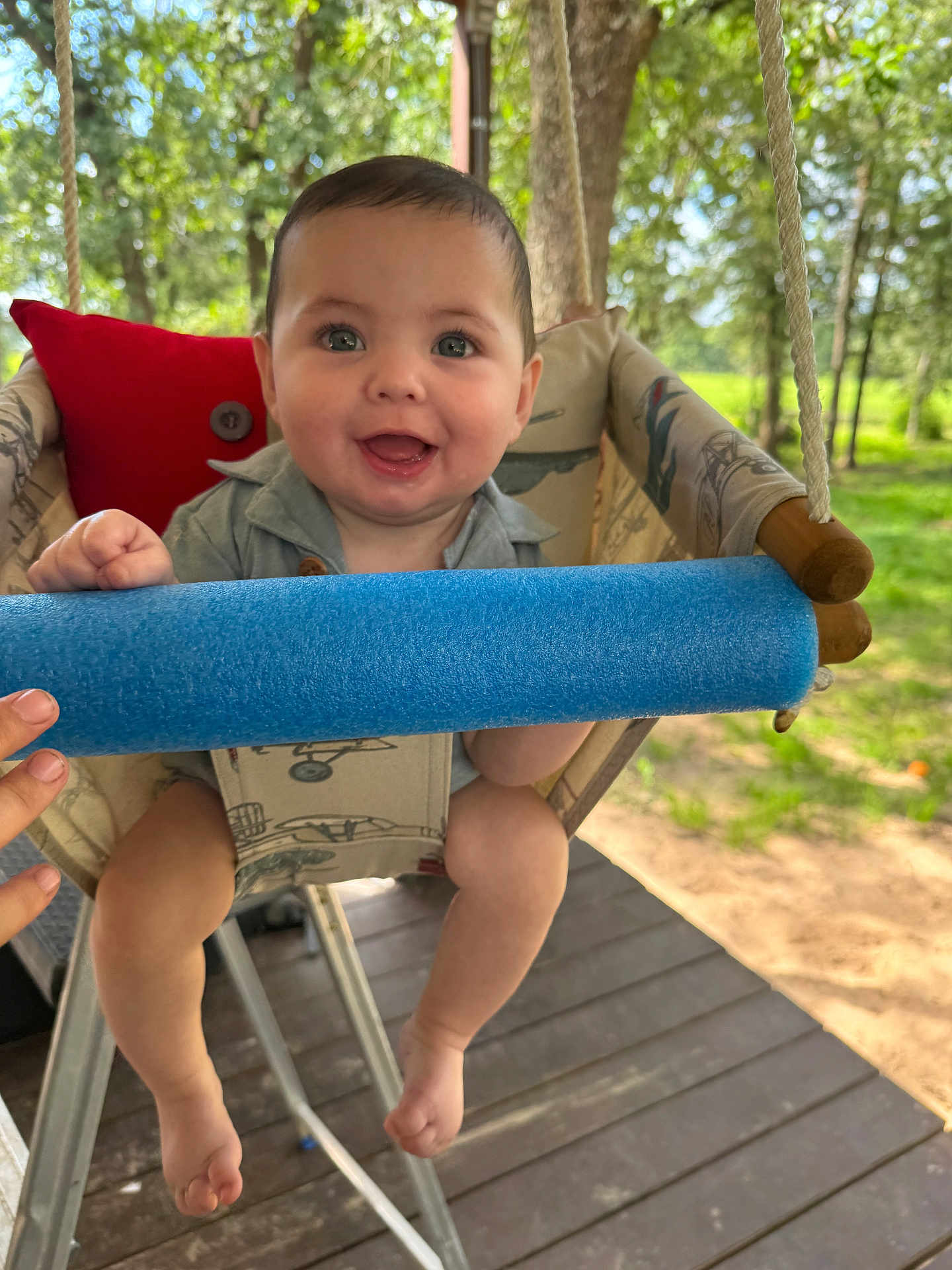 Ricky joined the competition — help win amazing prizes! baby, child, swing, blue_foam, outdoor, greenery, trees, smiling, happy, seat, wooden_floor, sunlight, hand, play, nature, infant, cute, portrait, daylight, summer