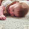 baby, smiling, lying_down, carpet, blanket, indoor, child, happy, cute, infant, soft_texture, head, face, skin, clothing, relaxed, toddler, young_child, portrait, cozy