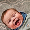Wyatt joined the competition — help win amazing prizes! baby, laughing, smiling, child, infant, face, happy, cheeks, clothing, dinosaur, patterned_carpet, portrait, cute, cozy, indoor, young_child, head, eyes_closed, mouth_open, skin