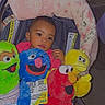 Damarionna joined the competition — help win amazing prizes! baby, child, stroller, plush_toys, sesame_street, elmo, cookie_monster, big_bird, colorful, portrait, indoor, sitting, infant, smiling, toys, blanket, pink_clothing, blue_toy, red_toy, yellow_toy